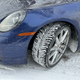 a blue 2023 porsche 911 carrera on a snow-covered road in michigan